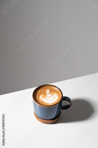 Cup of coffee latte on white table at coffee shop in morning time . Top view. Copy space.Coffee latte topview.