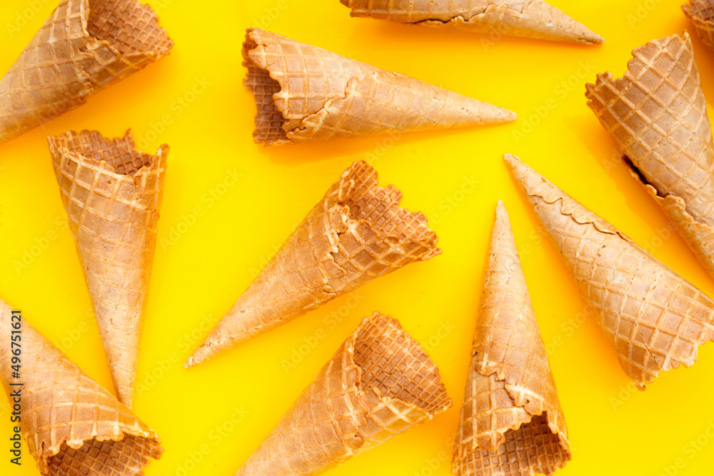 Empty ice cream cone on yellow background. Empty ice cream cone on yellow background.