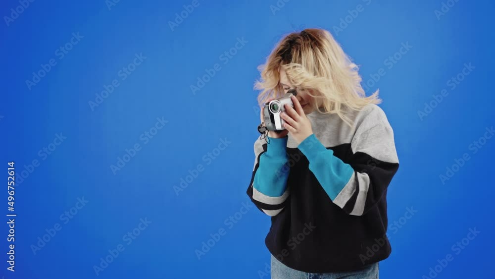 Happy Light-Haired Woman Is Using A Retro Camcorder For Shooting Video Happy Light-Haired Woman Is Using A Retro Camcorder For Shooting Video