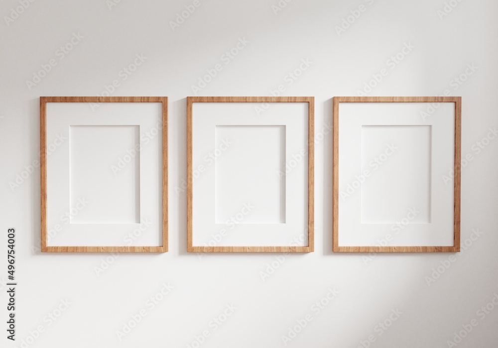 Three empty photo frame for mockup in empty white room. 3D rendering. Three empty photo frame for mockup in empty white room. 3D rendering.
