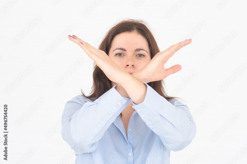Young woman showing stop by hands, keeps palms outstretches, makes refusal gesture, rejects offer on white backround Young woman showing stop by hands, keeps palms outstretches, makes refusal gesture, rejects offer on white backround