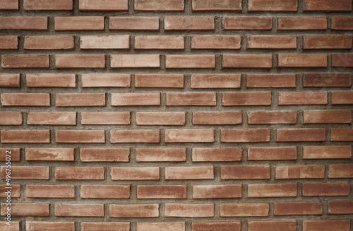 A square brown brick wall interior background sets the scene for the show.