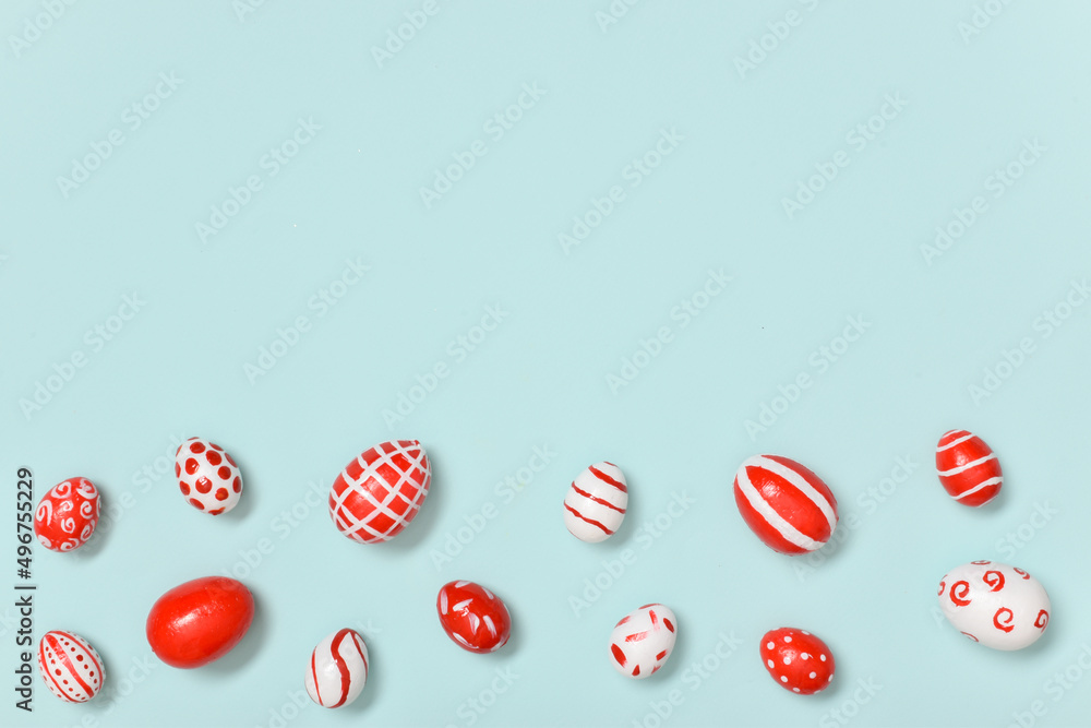 Easter banner with Easter red and white eggs on a light blue background. A place to copy. Flat position, top view Easter banner with Easter red and white eggs on a light blue background. A place to copy. Flat position, top view