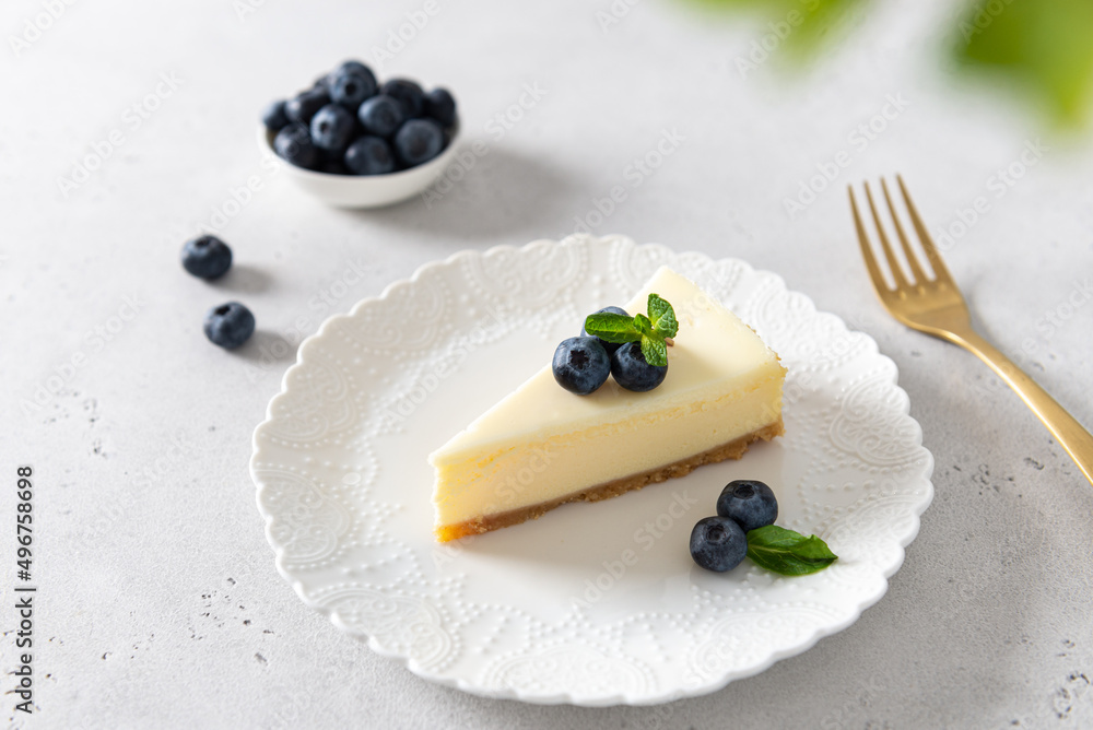 Homemade vanilla cheesecake with blueberry and mint on white background - healthy organic summer dessert pie cheesecake. Cheesecake New York. Side view, close up. Menu, recipe, confectionery Homemade vanilla cheesecake with blueberry and mint on white background - healthy organic summer dessert pie cheesecake. Cheesecake New York. Side view, close up. Menu, recipe, confectionery