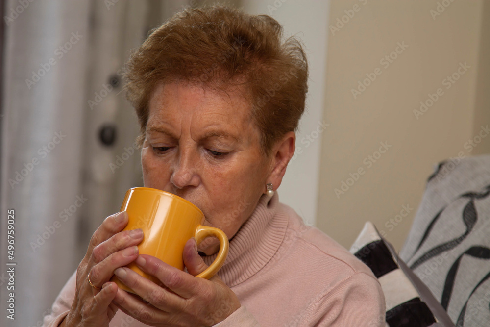 relaxed senior woman having cup of coffee at home relaxed senior woman having cup of coffee at home