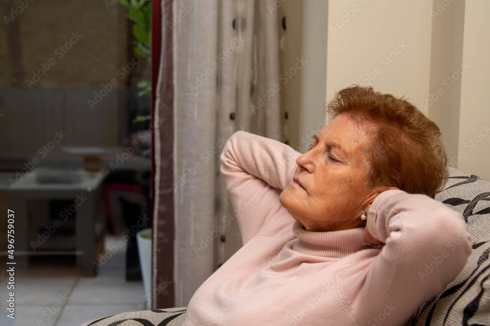Woman relaxing and sleeping on the couch at home Woman relaxing and sleeping on the couch at home