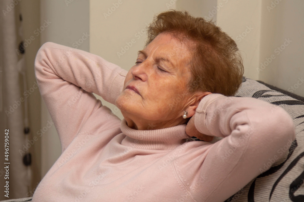 Fototapeta premium Woman relaxing and sleeping on the couch at home