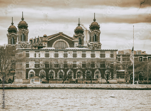 Ellis Island building exterior, view from moving boat in New Yor photo