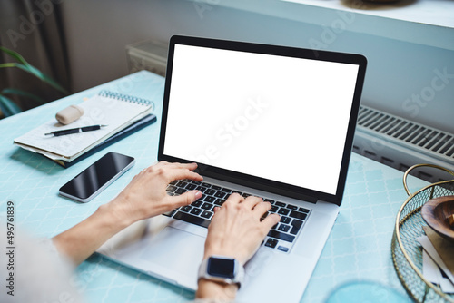 Freelancer typing on laptop working at home