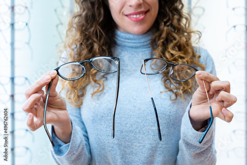 Photos Close-up of a happy female client showing two glasses, making a choice