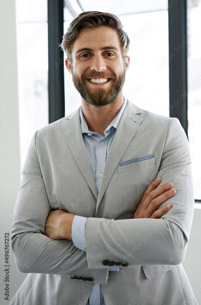 I intend to rise to the top. Portrait of a confident young businessman standing with his arms crossed in his office. I intend to rise to the top. Portrait of a confident young businessman standing with his arms crossed in his office.