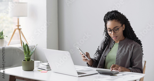 Woman accountant using calculator and computer in office panoramic banner, finance and accounting concept photo