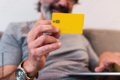 Man using credit card for paying financial bills at home photo