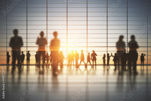Backlit crowd of businesspeople working together in bright office interior with sunlight. Teamwork and corporate workplace concept. Double exposure.