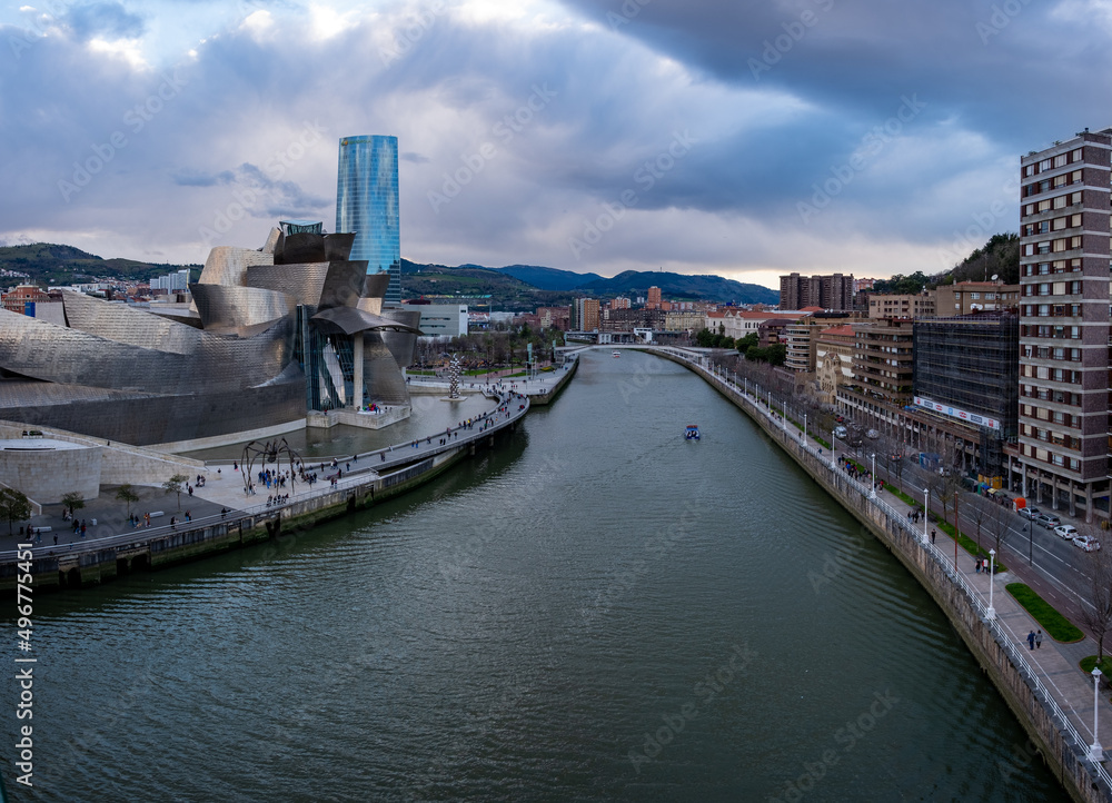 Panoramic view of the Nervión river and the Guggenheim museum on a cloudy day, of the city in Bilbao, Spain, 04-05-2022