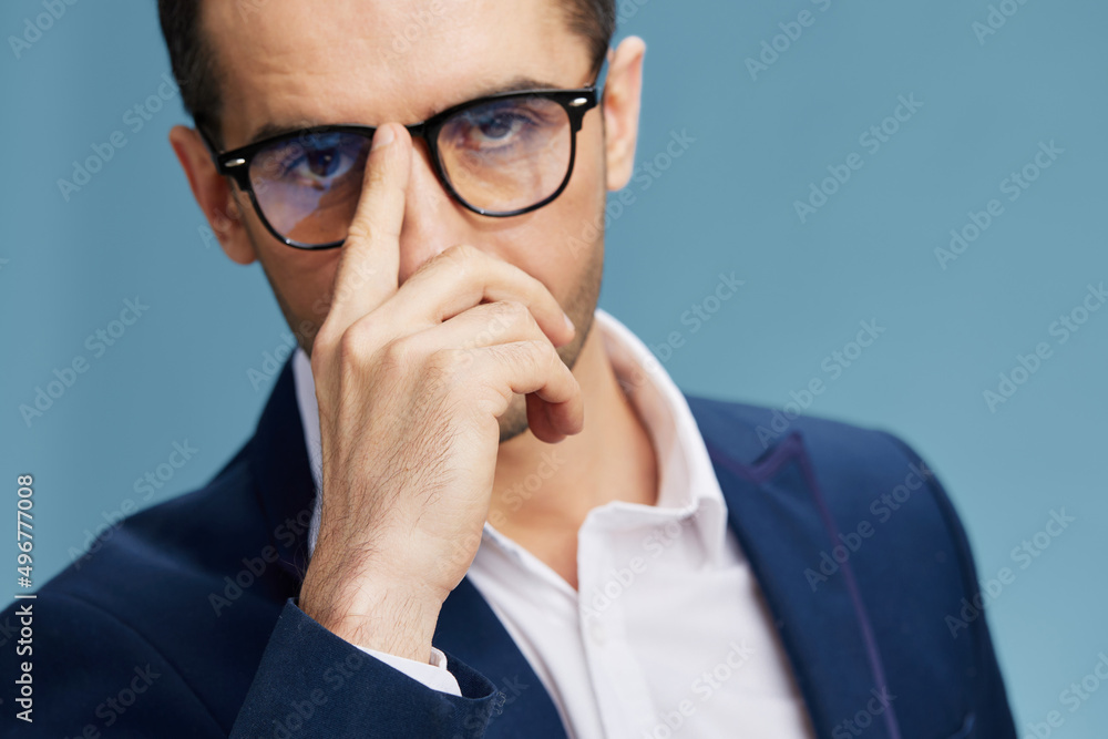 handsome man adjusts his glasses with his finger self-confidence close-up handsome man adjusts his glasses with his finger self-confidence close-up