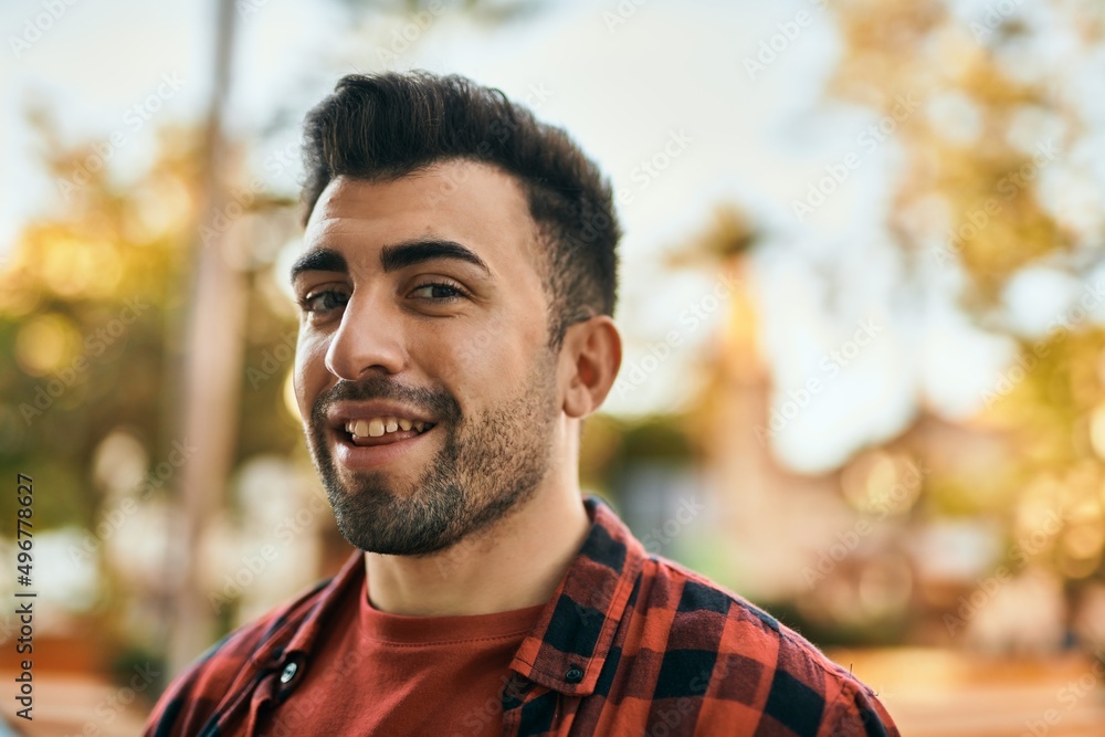 Young hispanic man smiling happy standing at the city. Young hispanic man smiling happy standing at the city.