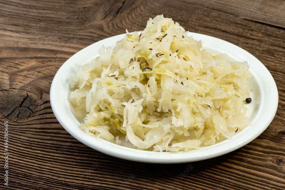 Homemade pickled sauerkraut on a white plate Homemade pickled sauerkraut on a white plate