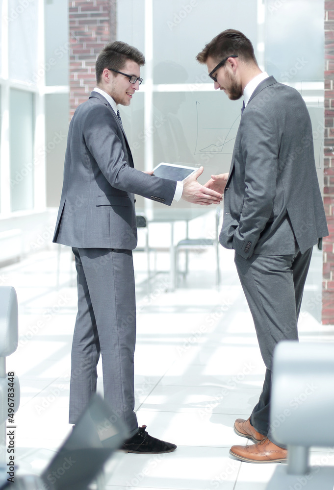 Fototapeta premium handshake two employees standing in the office