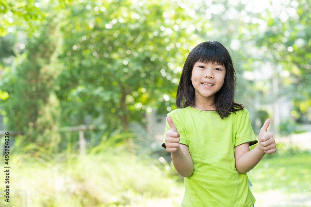 portrait asian kid, child enjoy and happy, the girl is smiling, thumbs up kid portrait asian kid, child enjoy and happy, the girl is smiling, thumbs up kid