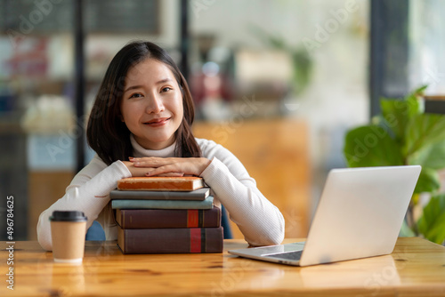 Canvas Print Education study abroad, Asian student girl look at laptop while doing homework m