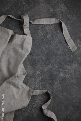 Apron on grey rust textured background. Copy space.