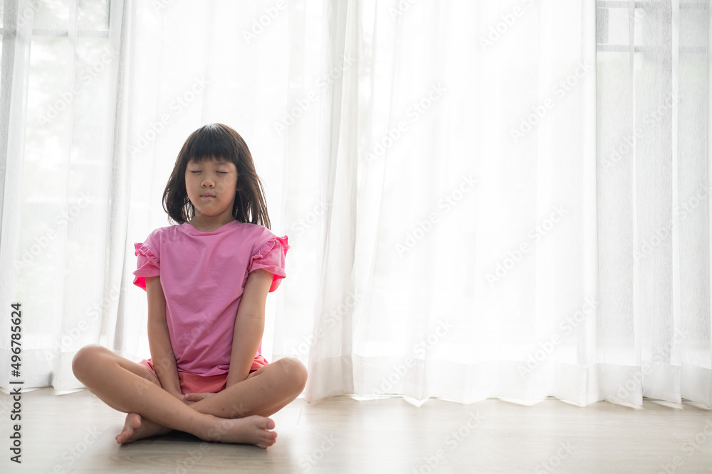 Asian girl meditating, lovely kid