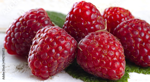 image of raspberries with leaves on a white background