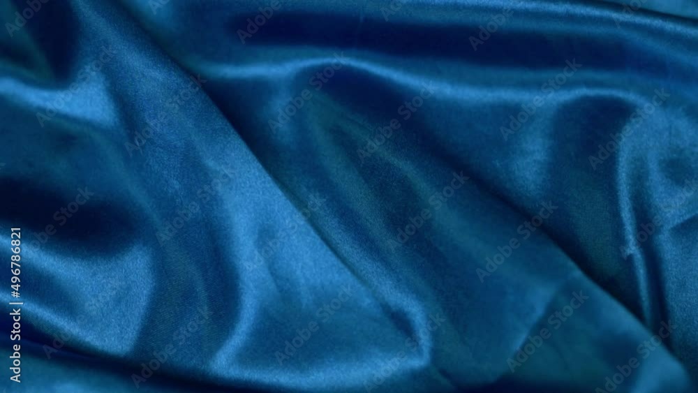 Shiny Blue Polyester Fabric, Textile, Synthetic Material, Fabric Texture, Closeup. Abstract Background from Blue Smooth Shiny Synthetic Fabric. Sewing Factory. Shiny Blue Polyester Fabric, Textile, Synthetic Material, Fabric Texture, Closeup. Abstract Background from Blue Smooth Shiny Synthetic Fabric. Sewing Factory.