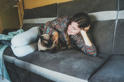 Young woman at home resting with her pet