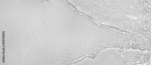 Transparent white clear water wave surface texture with splashes and bubbles. Abstract summer banner background Water waves in sunlight with copy space Cosmetic moisturizer micellar toner emulsion