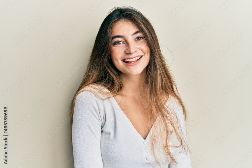 Young caucasian woman wearing casual white t shirt with a happy and cool smile on face. lucky person. Young caucasian woman wearing casual white t shirt with a happy and cool smile on face. lucky person.