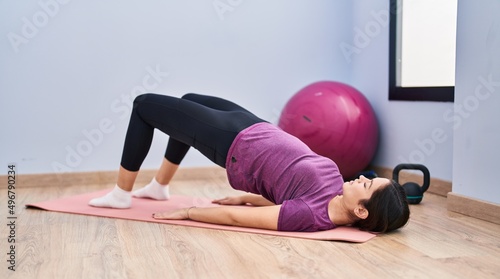 Young woman training abs exercise at sport center