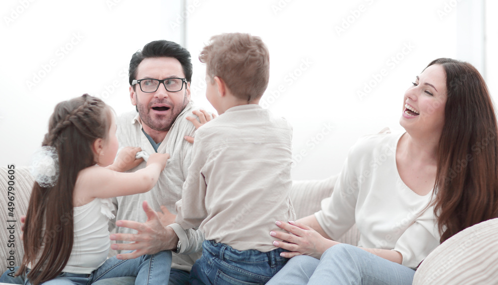 parents play with children sitting on the couch parents play with children sitting on the couch