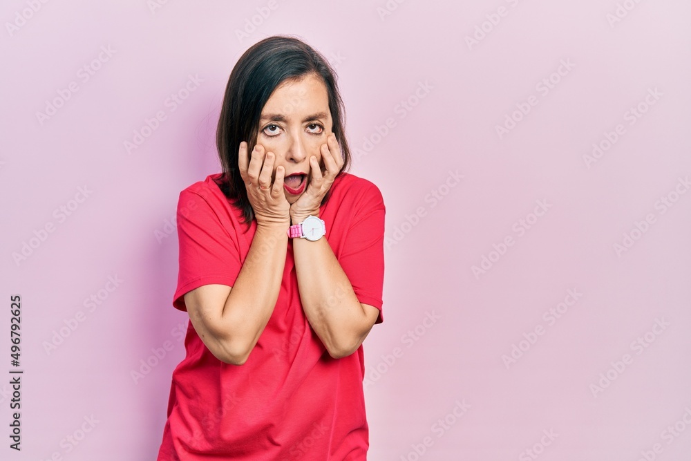 Middle age hispanic woman wearing casual clothes tired hands covering face, depression and sadness, upset and irritated for problem
