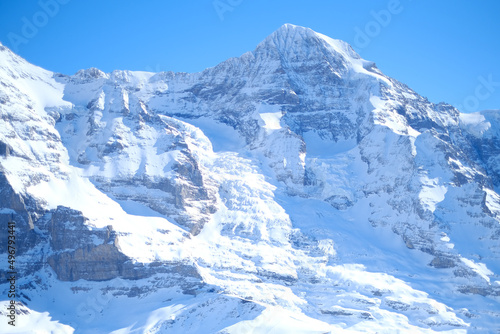 Beautiful shot of snowy Wengen mountains Ski in Grindelwald, Switzerland with a blue sunny sky © Wirestock Creators