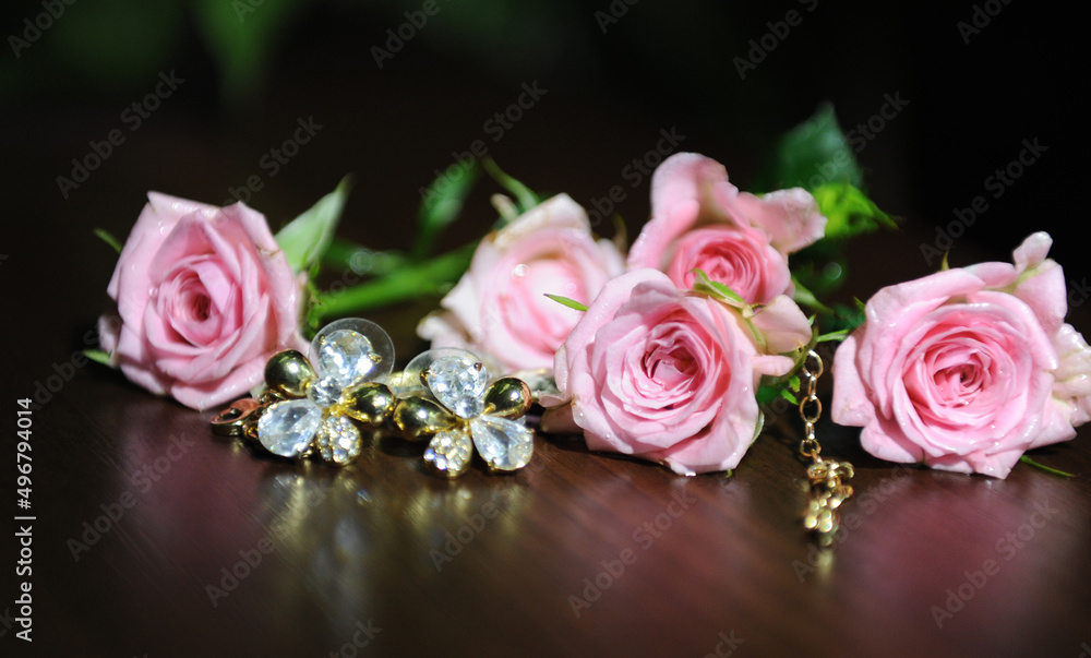 Pale pink roses lie on a dark mirror background for advertising there is a place for text. High quality photo Pale pink roses lie on a dark mirror background for advertising there is a place for text. High quality photo