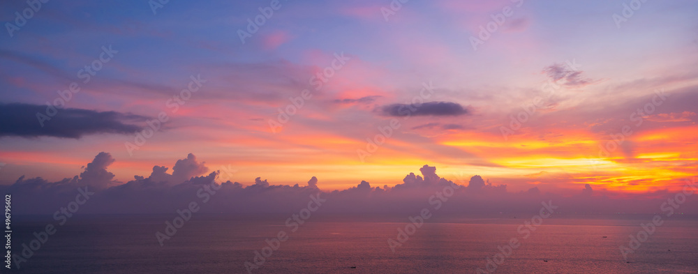 Beautiful dramatic and colorful sky at sunset over the sea, Banner panorama
