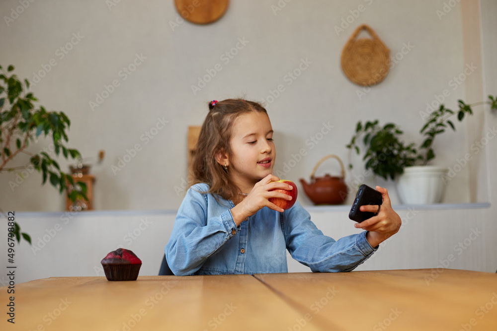 Beautiful young girl filming her blog broadcast about healthy food at the home Beautiful young girl filming her blog broadcast about healthy food at the home