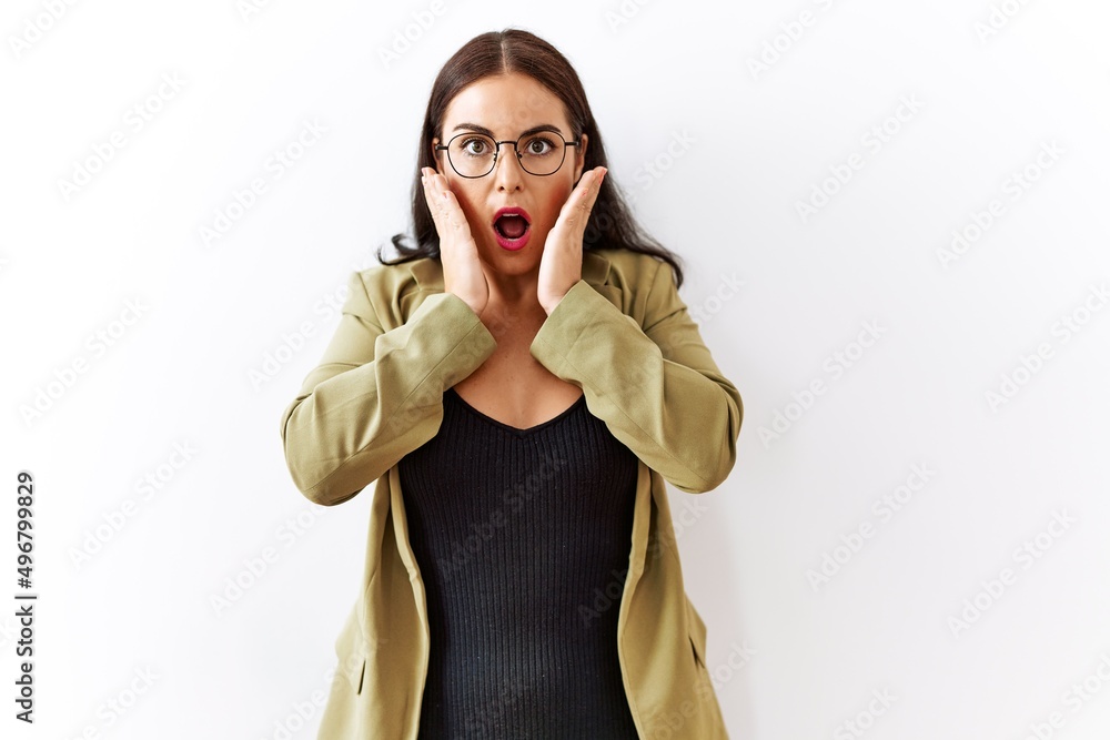 Young brunette woman standing over isolated background afraid and shocked, surprise and amazed expression with hands on face Young brunette woman standing over isolated background afraid and shocked, surprise and amazed expression with hands on face