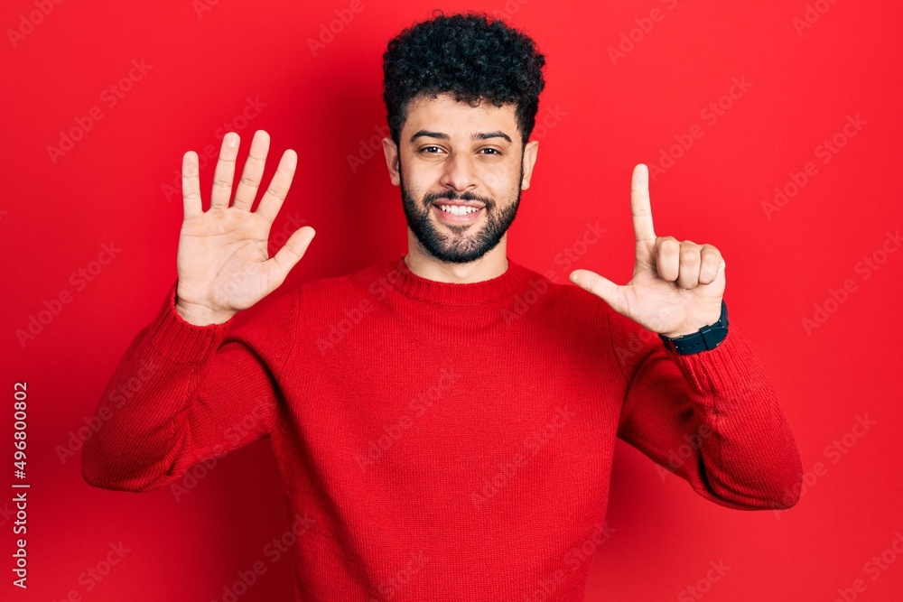 Young arab man with beard wearing casual red sweater showing and pointing up with fingers number seven while smiling confident and happy. Young arab man with beard wearing casual red sweater showing and pointing up with fingers number seven while smiling confident and happy.