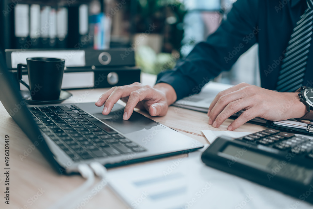Accountant working on calculator to calculate company data, document and report on desk office. Accounting business concept. Accountant working on calculator to calculate company data, document and report on desk office. Accounting business concept.
