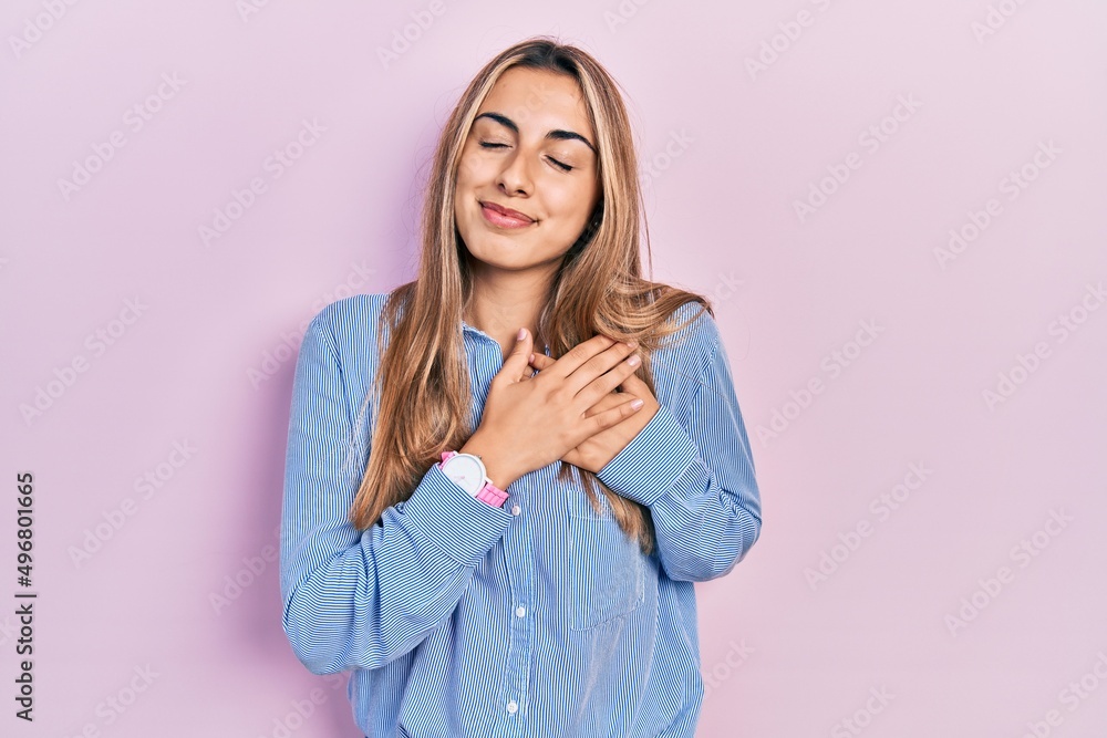 Beautiful hispanic woman wearing casual shirt smiling with hands on chest, eyes closed with grateful gesture on face. health concept. Beautiful hispanic woman wearing casual shirt smiling with hands on chest, eyes closed with grateful gesture on face. health concept.