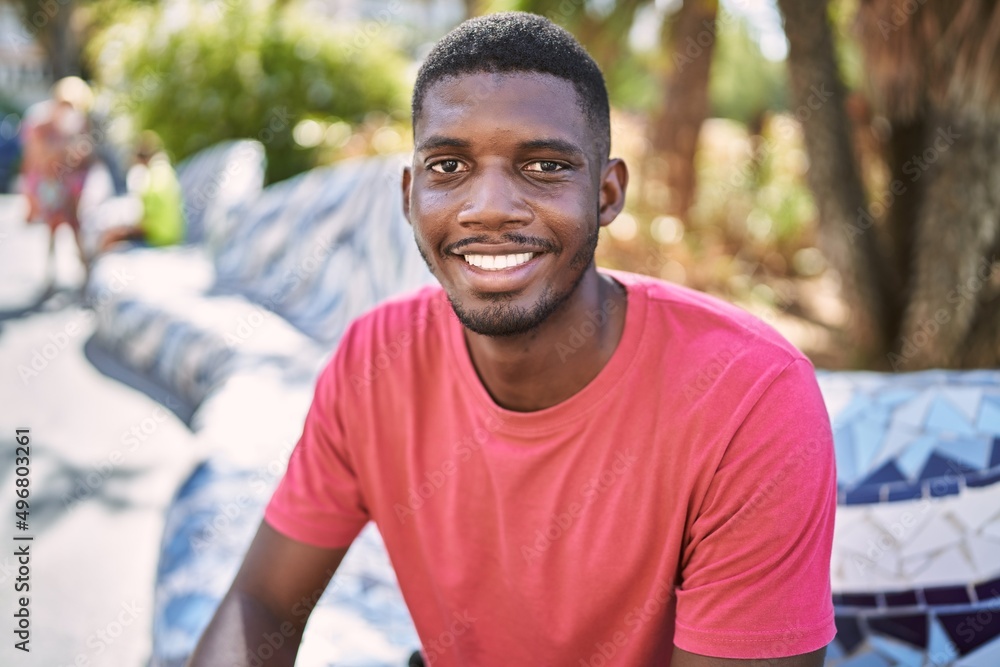 Young african man smiling confident at park