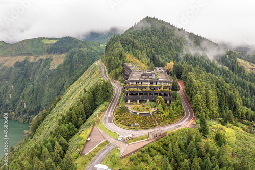 Aerial view of a hotel ruins, an abandoned building along the road near Candelaria, Azores Islands, Portugal.