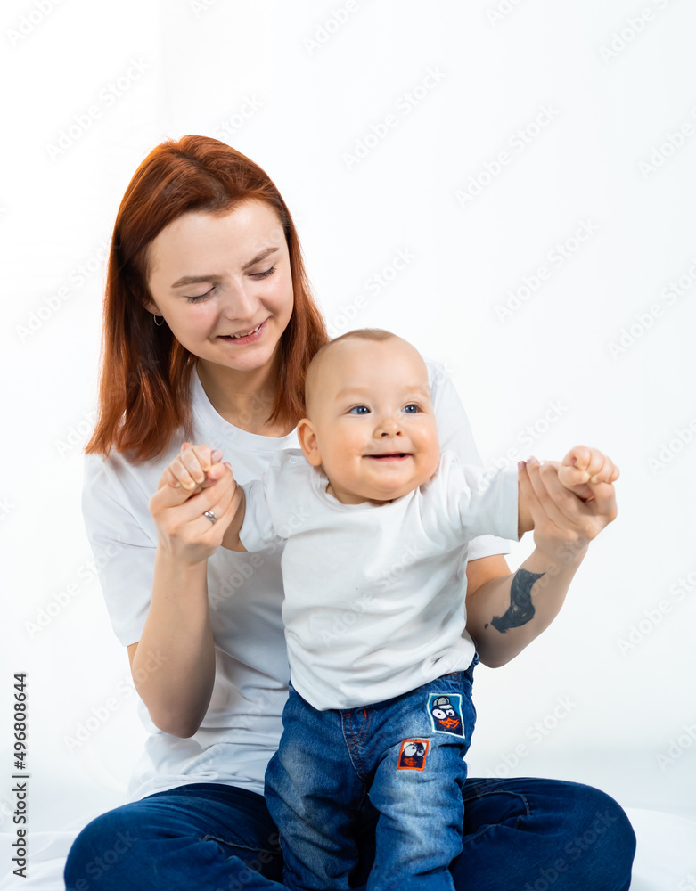 mother with a small child on a white background. a happy family. baby mother with a small child on a white background. a happy family. baby