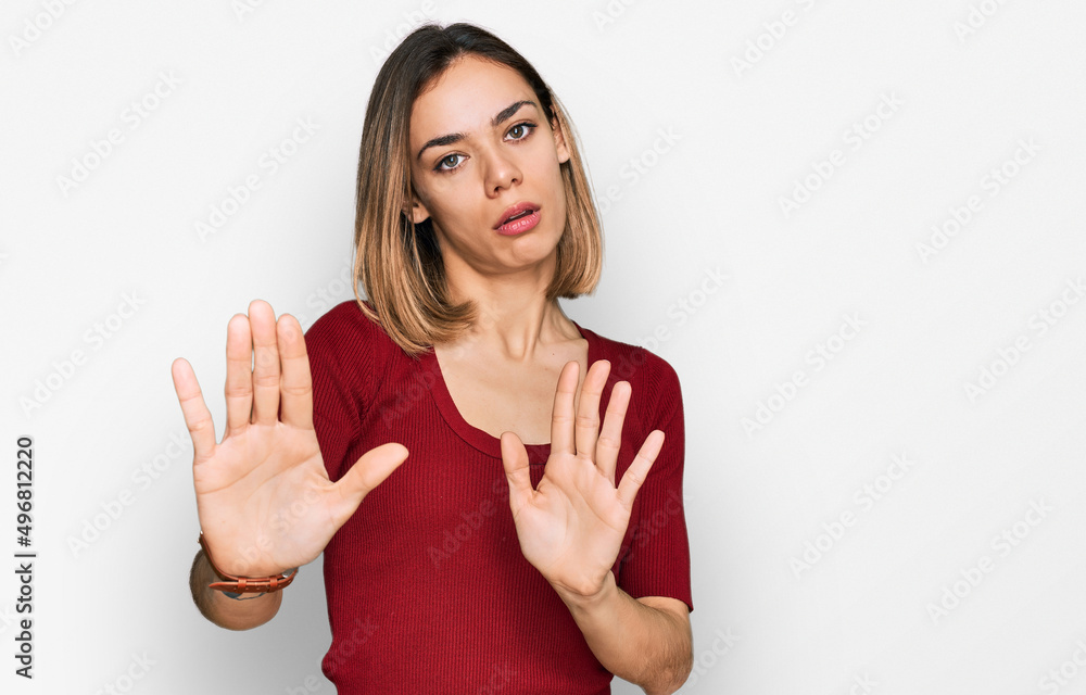 Young blonde girl wearing casual clothes moving away hands palms showing refusal and denial with afraid and disgusting expression. stop and forbidden. Young blonde girl wearing casual clothes moving away hands palms showing refusal and denial with afraid and disgusting expression. stop and forbidden.