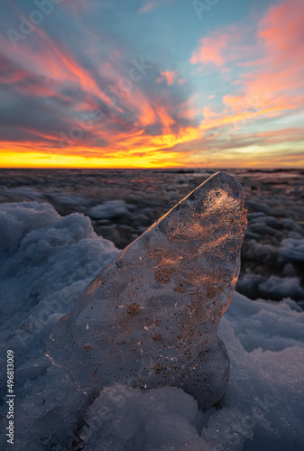 Close-up of piece of ice on snow on Baltic sea shore.