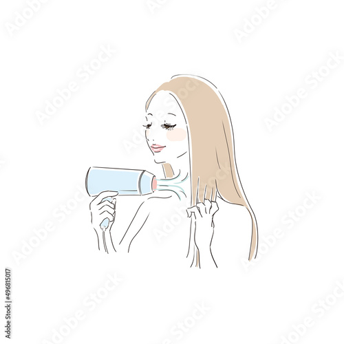 ヘアドライヤーで髪を乾かす美しい女性