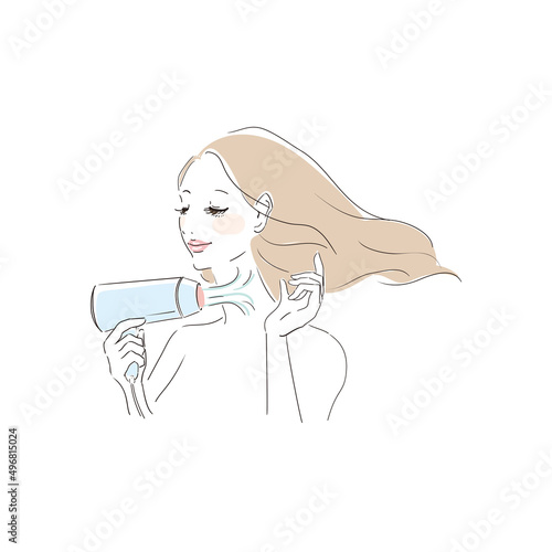 ヘアドライヤーで髪を乾かす美しい女性